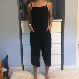 Black jumpsuit, flowy pant legs, form fitting top